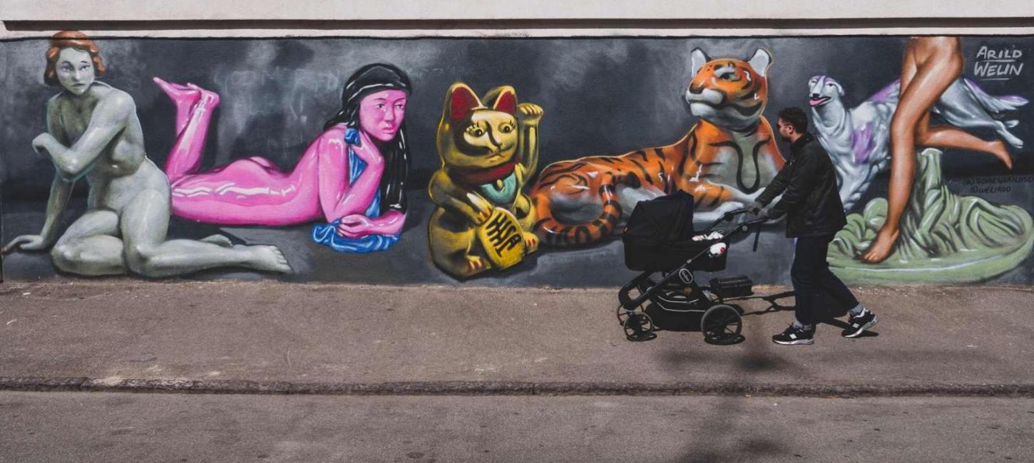 A father walking a stroller in the streets of Vesterbro, Copenhagen.