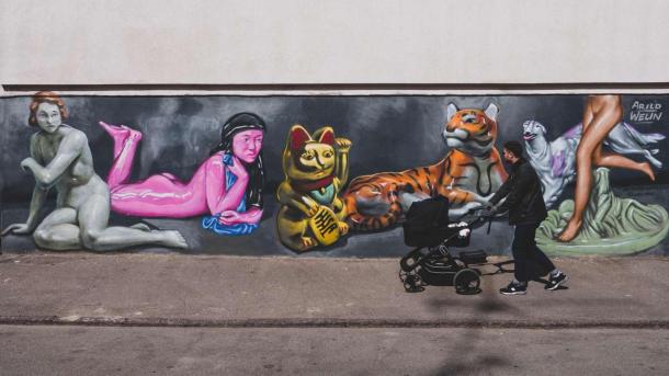 A father walking a stroller in the streets of Vesterbro, Copenhagen.